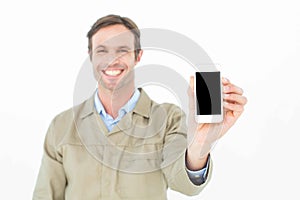 Smiling delivery man showing smart phone