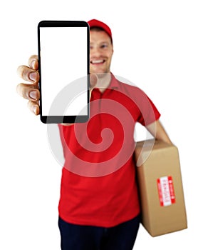 Smiling delivery man showing smartphone with blank screen