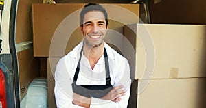 Smiling delivery man sitting in his van