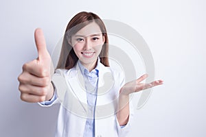 Smiling dentist woman thump up