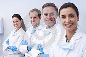 Smiling dentists standing with arms crossed