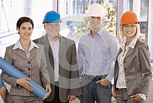 Smiling designer team wearing hardhat