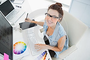 Smiling designer using computer and digitizer