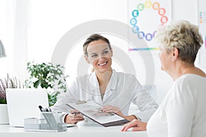 Smiling dietician with her patient photo