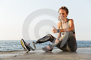 Smiling disabled athlete woman with prosthetic leg