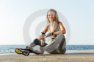 Smiling disabled athlete woman with prosthetic leg photo