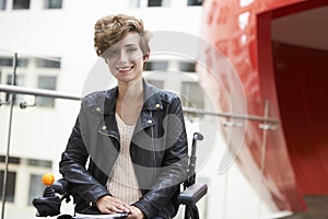 Smiling disabled female university student on mezzanine