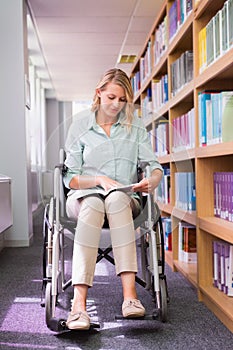 Smiling disabled student in library picking book