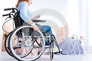 Smiling disabled woman looking at the book