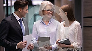 Smiling diverse colleagues have fun discussing business ideas