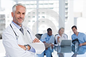 Smiling doctor with arms folded