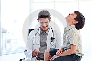 Smiling doctor checking a child's reflex