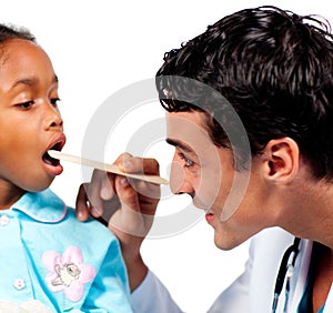 Smiling doctor checking little girl's throat