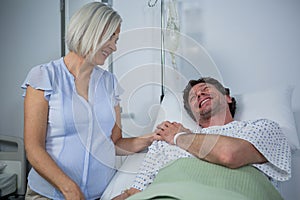 Smiling doctor consoling a patient