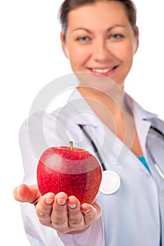 Smiling doctor holding a red apple