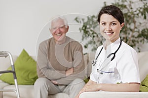 Smiling doctor during home visit