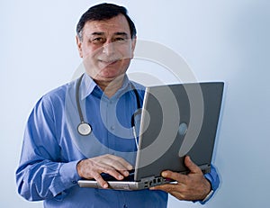 Smiling doctor with laptop