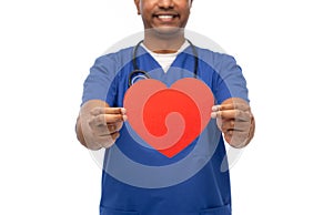 smiling doctor or male nurse with red heart