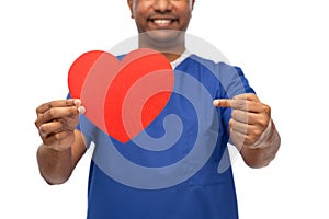 smiling doctor or male nurse with red heart