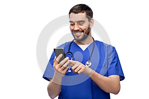 smiling doctor or male nurse using smartphone