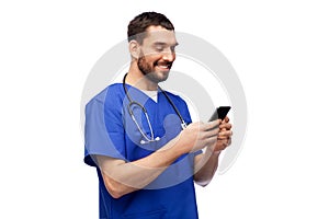 smiling doctor or male nurse using smartphone