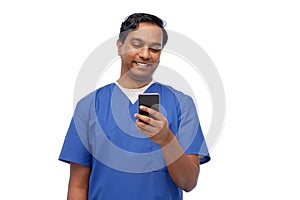 smiling doctor or male nurse using smartphone