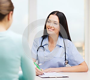 Smiling doctor or nurse with patient