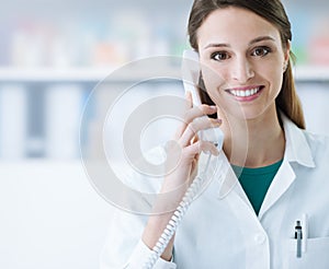 Smiling doctor phone calling