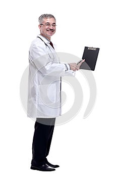 smiling doctor pointing to a blank space in the clipboard.