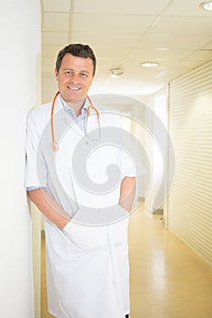 smiling doctor posing and looking at camera in hospital medical