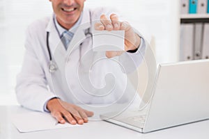 Smiling doctor showing a blank