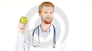 Smiling Doctor showing green apple to the camera