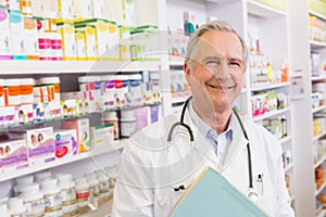 Smiling doctor with stethoscope holding notebooks