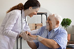 Smiling doctor support comfort old male patient in hospital