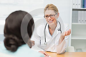 Smiling doctor talking to her patient
