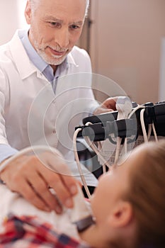 Smiling doctor using ultrasound linear transducer in the hospital