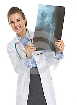 Smiling doctor woman looking out from fluorography