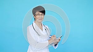 Smiling doctor woman over blue background