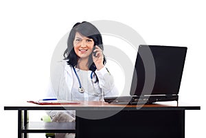 Smiling doctor woman speaking by phone