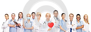 Smiling doctors and nurses with red heart