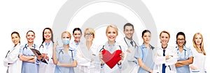 Smiling doctors and nurses with red heart