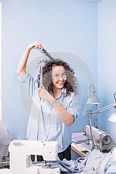 Smiling dressmaker using scissors to make haircut. unpredictable sollution