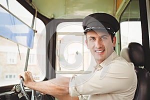 Smiling driver driving the school bus