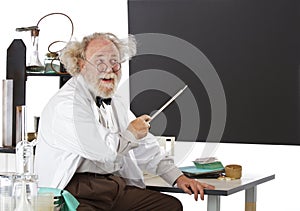 Smiling eccentric scientist points to blackboard