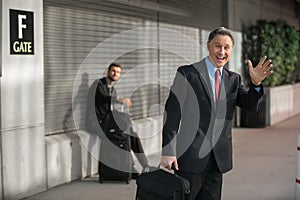 Smiling Ecstatic Businessman At Aiport Gate