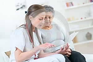 Smiling elderly lady with supportive doctor