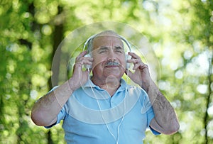 Smiling elderly man enjoying his music