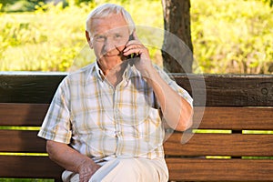 Smiling elderly man with phone.