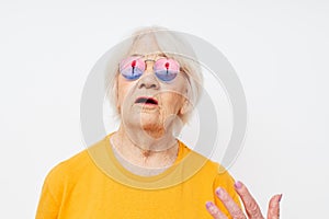 smiling elderly woman in fashionable glasses hand gestures close-up emotions