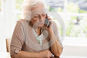 Smiling elderly woman phone calling